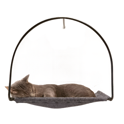 A gray cat sleeping in a hanging cat bed.
