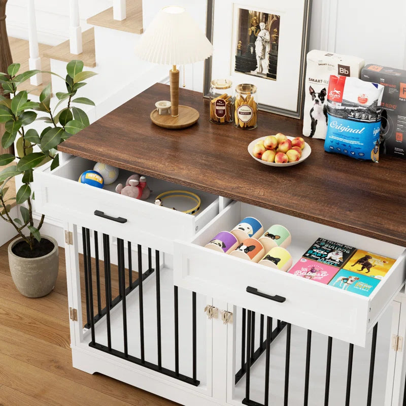 White dog crate furniture with black metal bars and walnut top, featuring storage drawers holding pet accessories and treats.