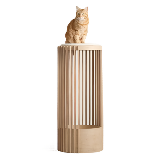 An orange tabby cat sits atop a tall, cylindrical cat tree with wooden slats.
