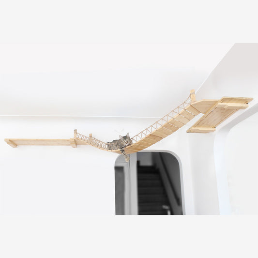 A cat lounging on a wall-mounted wooden bridge inside a house.